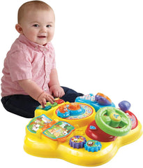 VTech Baby Adventure Play Table - Masă de joacă colorată pentru bebeluși cu 6 câmpuri de joc și elemente interactive & Baby My First Song Book Carte colorată cu 6 pagini și elemente mobile pentru joacă Jucarii Bebe Naty Shop