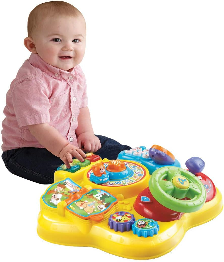 VTech Baby Adventure Play Table - Masă de joacă colorată pentru bebeluși cu 6 câmpuri de joc și elemente interactive & Baby My First Song Book Carte colorată cu 6 pagini și elemente mobile pentru joacă Jucarii Bebe Naty Shop
