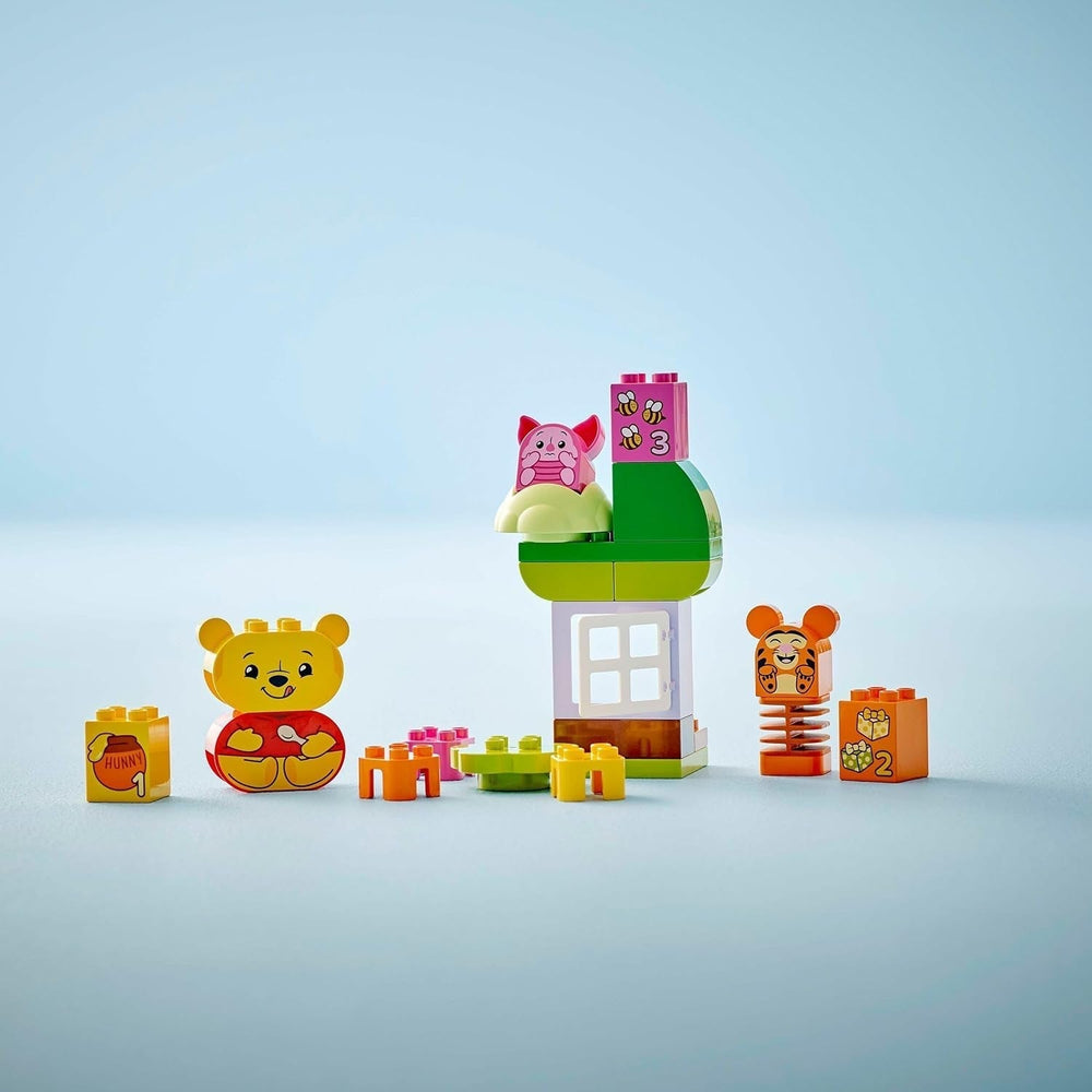 LEGO DUPLO - Fiesta de cumpleaños de Winnie the Pooh de Disney - juguete educativo para preescolares - juego de 3 minifiguras, incluidos Winnie the Pooh, Tigger y Piglet - idea de regalo para niños y niñas a partir de 1,5 años 10457 Juegos de construcción Beuche den LEGO-Store
